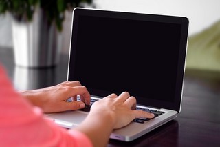 hands typing at a computer